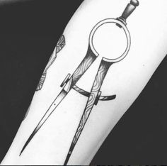 a black and white photo of a tattoo with scissors