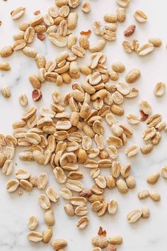 some nuts are laying on a white counter top and there is no image here to provide a caption for