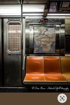 a subway car with orange seats and a map on the wall