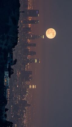 the full moon is seen in black and white over new york's manhattan skyline