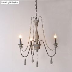 a chandelier with three lights hanging from it