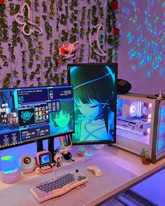 two computer monitors sitting on top of a desk next to a keyboard and monitor screen