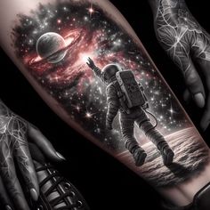 an astronaut tattoo on the arm with space and stars in the sky behind it, as well as two hands