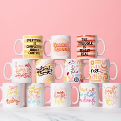 there are many coffee mugs stacked on top of each other in different colors and designs