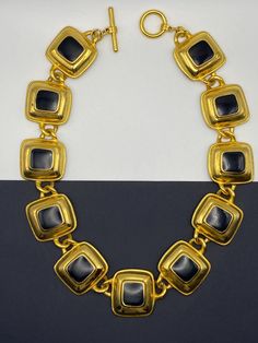 Amazing statement vintage neck piece , classy edgy combination of gold and black. This neck piece will definitely add so much chic and uniqueness. Secondhand in a great condition. Super sophisticated and stylish Square size 1'x1' Length 17.5' Luxury Black Enamel Elegant Necklace, Luxury Black Enamel Statement Necklace, Luxury Gold-tone Statement Necklaces, Classy Edgy, Vintage Black Brass Necklace, Vintage Collection Yellow Gold Brass Necklace, 14k Gold Black Tarnish-resistant Necklace, Gold Statement Necklace, Necklace Chain Lengths