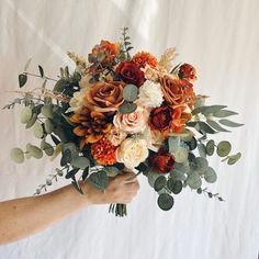 a person holding a bouquet of flowers in their hand