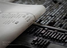 an open book sitting on top of a table next to a computer keyboard and mouse