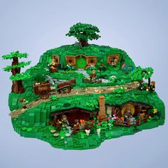 a lego house made to look like it is on top of a hill with trees