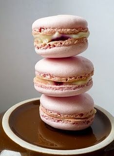 three pink macaroons stacked on top of each other