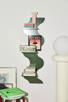 a book shelf with books on it next to a lamp and other items in a room