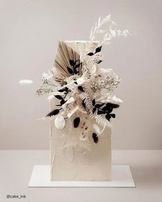 a white sculpture with black and white flowers on it