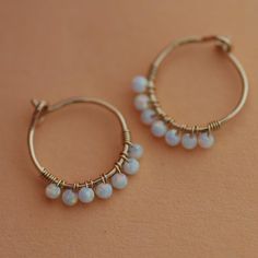 ❖ ONE PAIR 14K SOLID GOLD hoop earrings - ONE PAIR  Comfortable lightweight design. Handmade dainty hoop earrings with seven wire-wrapped white opals (2mm). Features: ♦ Material: 14K SOLID GOLD Yellow / Rose ♦ Wire thickness: 20 gauge = 0.8 mm  ♦ Please choose the Inner hoop diameter:  SMALL: 20mm (please see listings photos) ➤ OPENING & CLOSING Your nose hoop is a 'seamless' ring.  Please use a horizontal opening and closing procedure shown in the listing pics!  By opening in a horizontal motio Beaded Hoop Earring, Hoop Earrings Wedding, Dainty Hoop Earrings, Earrings Wire, Solid Gold Earrings, Nose Hoop, Earrings Beaded, Pearl Hoop Earrings, Earrings Pearl