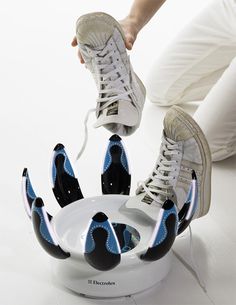 a person sitting on top of a white plate with blue and black shoes in it