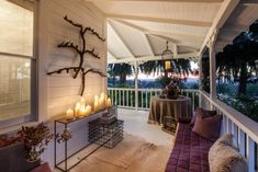 the porch is decorated with candles and decor