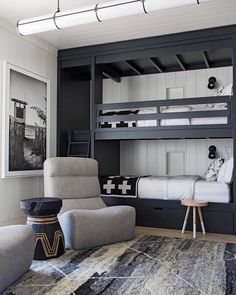 a bedroom with bunk beds and chairs in it