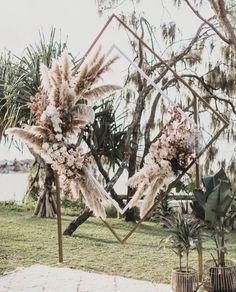 an outdoor ceremony setup with flowers and feathers