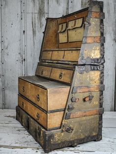 an old trunk sitting on top of a wooden floor