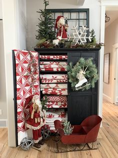 a christmas display with santa clause and other holiday decorations on it's sideboard