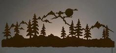 the silhouette of a bird flying over a forest