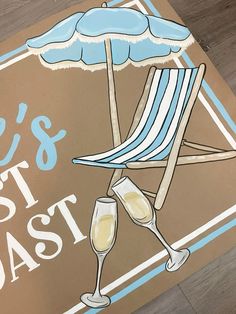 there is a sign that says it's the best coast with a beach chair and umbrella