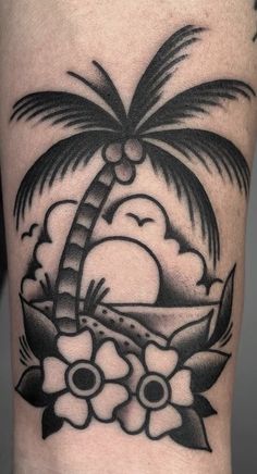 a black and white tattoo with a palm tree