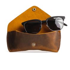 Soft and sturdy, natural leather is the perfect material for a protective sunglasses case. A clean design finished with neatly stitched sides and our signature snap. Toss in your tote and seek some sun! Dimensions: Width: 6" Depth: 1 3⁄4"Height: 2 1⁄2 " No two PLG bags are alike! Please note: it is normal for all of our products, including Premium items, to have unique variations and character markings that are inherent to natural full-grain leather. Pebbled leathers are achieved naturally and n Everyday Textured Leather Pouch, Character Markings, Sunglasses Travel Case, Textured Leather Travel Pouch, Rectangular Shape, Leather Sunglasses Case, Portland Leather Goods, Unicorn Colors, Cute Sunglasses, Glasses Case