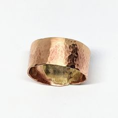 a close up of a gold ring on a white background