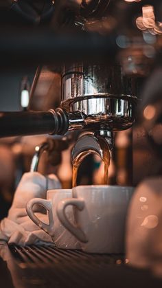 espresso machine pouring coffee into two cups