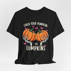 a black t - shirt that says check your pumpkin for pumpkins