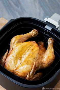 a whole chicken sitting in an air fryer