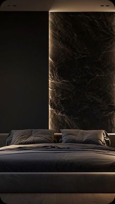 a large bed sitting in a bedroom next to a wall mounted light on it's side