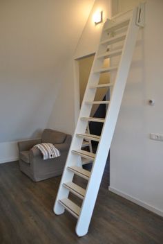 there is a white ladder in the corner of this room