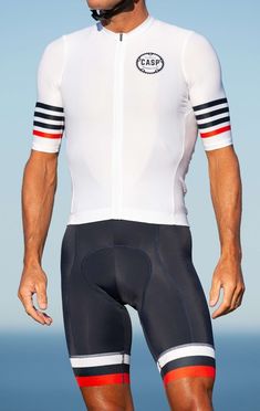 a man wearing a white and red cycling suit