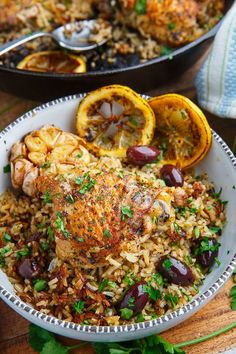 a bowl filled with rice, meat and olives