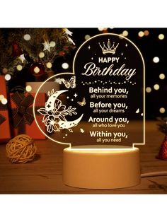 an illuminated birthday card with the words, happy birthday behind it is a heart shaped glass plaque