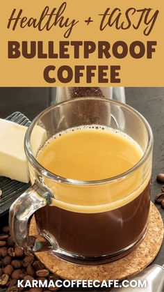 a glass cup filled with coffee next to beans and cheese