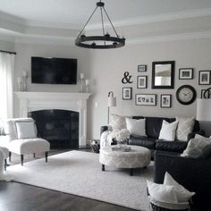 a living room filled with furniture and pictures on the wall