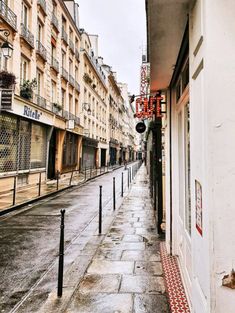 an empty city street is shown in the rain