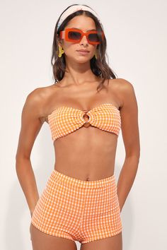 Beach days aren't complete without the Dippin' Daisy's Farrah Orange Gingham Swim Shorts! Crinkly stretch-knit, with a white gingham pattern, creates an elasticized high-waist and skimpy bottom coverage, perfect for pairing with your bikini top. PLEASE NOTE: Swimwear returned without the hygienic liner is non-refundable Fit: This garment fits true to size. Length: Above mid-thigh. Size medium Waist: Fitted - stretchy fabric allows custom fit. Hip: Fitted - stretchy fabric allows room for hips. F Orange Gingham, 70s Aesthetic, Vintage Swimwear, Gingham Pattern, Beach Days, Bottom Clothes, 70s Fashion, Stretchy Fabric, Swim Shorts