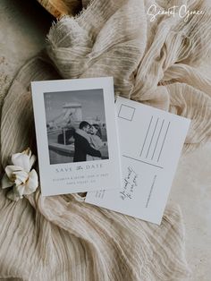 two wedding postcards sitting on top of a blanket