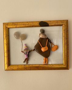 a framed photo with two small figurines in it