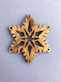 a wooden snowflake ornament on a blue background