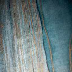 the fabric is blue and green with brown lines on it, as well as an orange stripe