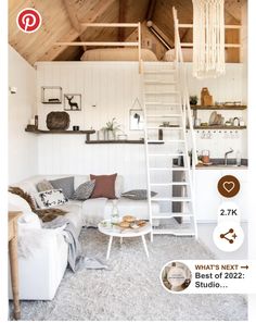 a living room filled with furniture next to a white couch and ladder on the wall