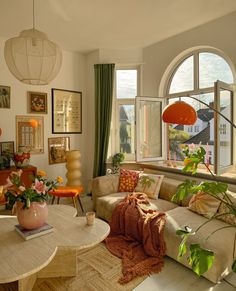 a living room filled with furniture and lots of windows