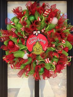 a christmas wreath with red and green decorations