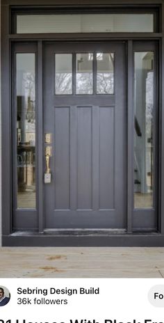 a black front door with two sidelights