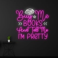 a neon sign that says buy me books and tell me i'm pretty