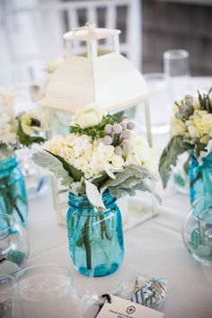 a table with vases filled with flowers on top of it