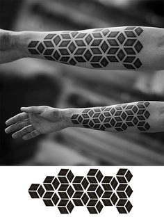 two hands with black and white geometric designs on them, one is holding the other hand